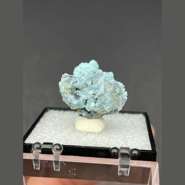 Cluster of frosted pale blue gibbsite spheres from Yunnan — detail view