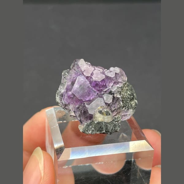 Tanzanite blue-violet fluorite on dark matrix from Fujian — alternate view