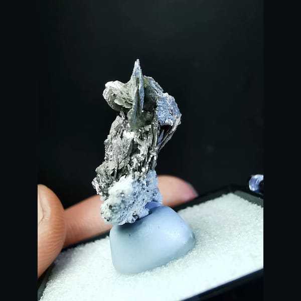 Bright silver platy loellingite with quartz — detail view