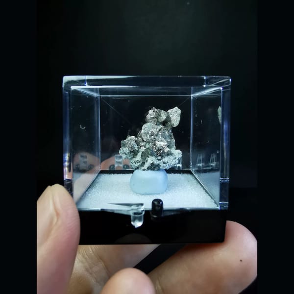 Bright silver platy loellingite with quartz — detail view