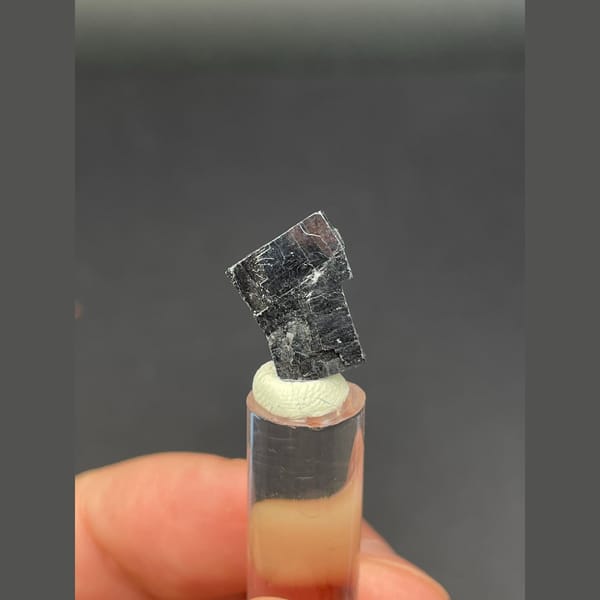 Small bright silver-grey cubic galena crystal — detail view