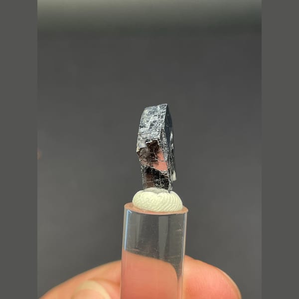 Small bright silver-grey cubic galena crystal — detail view