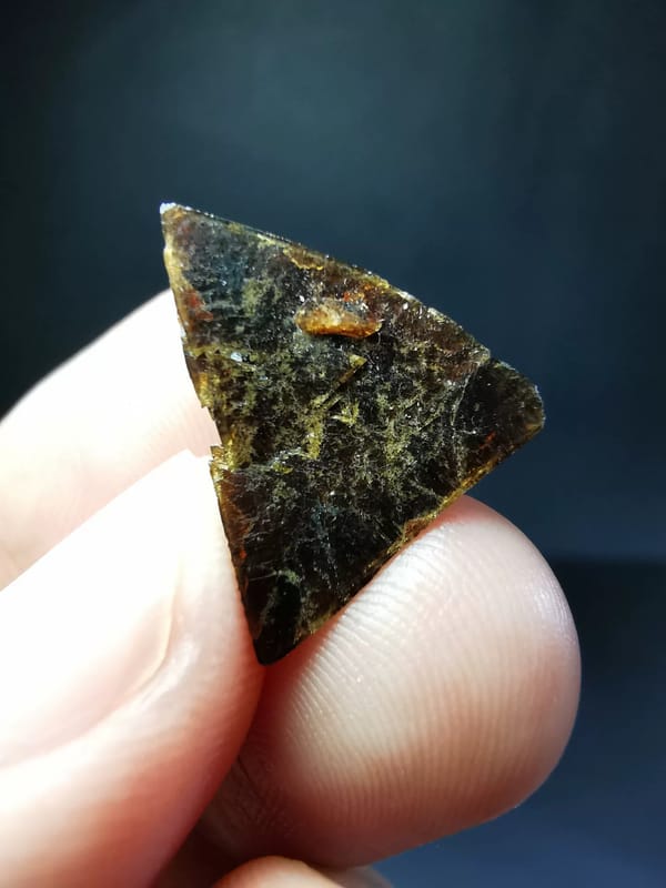 Front view of the exact triangular brown garnet crystal
