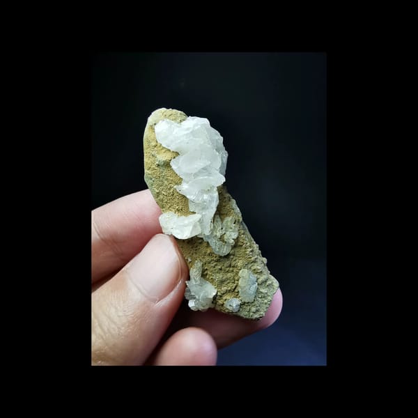 Yellow-coated double-terminated quartz with white calcite — complete front view