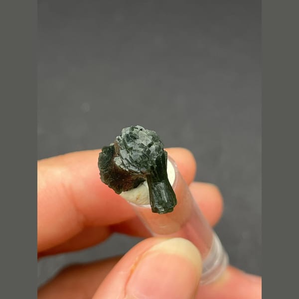 Small dark green radiating prehnite bowtie from Morocco — detail view