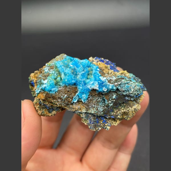 Sky-blue gibbsite crust with deep blue azurite on matrix from Yunnan — alternate view