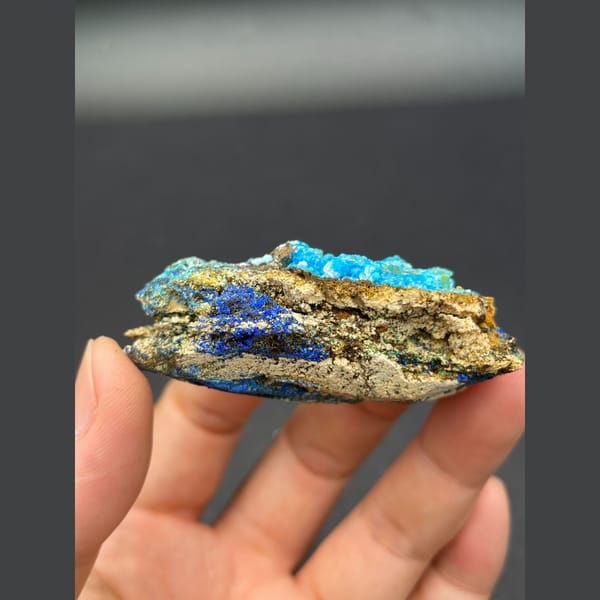 Sky-blue gibbsite crust with deep blue azurite on matrix from Yunnan — alternate view