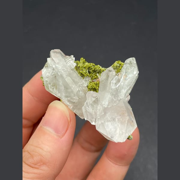 Water-clear quartz cluster with green epidote from Meigu, Sichuan — complete view