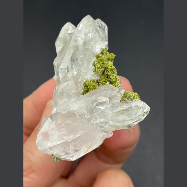 Water-clear quartz cluster with green epidote from Meigu, Sichuan — detail view