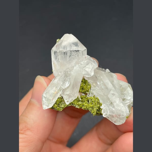 Water-clear quartz cluster with green epidote from Meigu, Sichuan — detail view