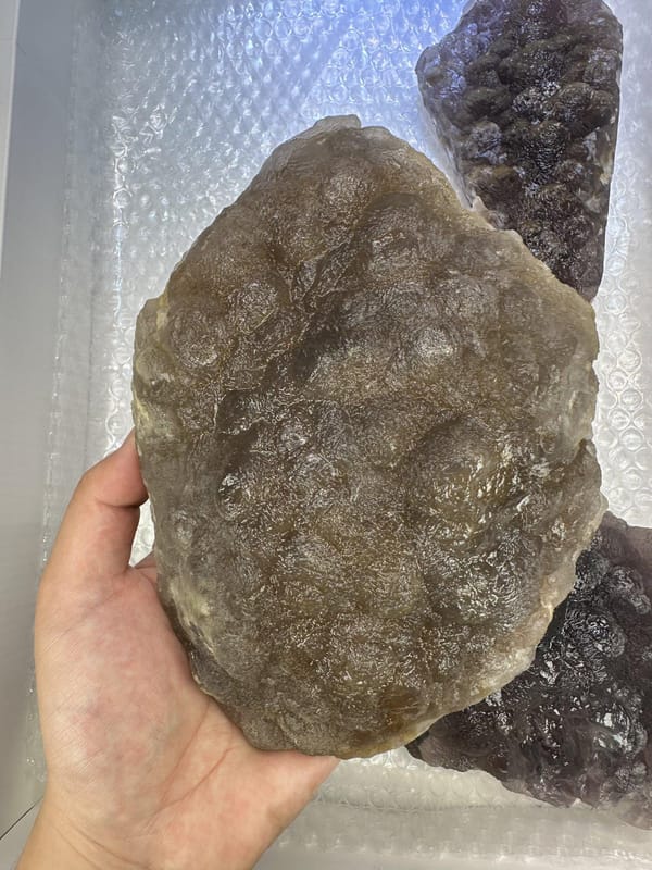 Four-Piece Purple Fluorite Lot, shown in hand for scale