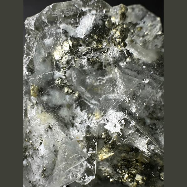 Clear glassy fluorite with golden pyrite cubes — detail view