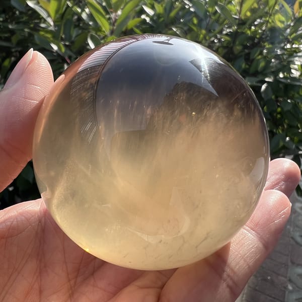 Rutilated fibres drifting upward through the clear citrine sphere