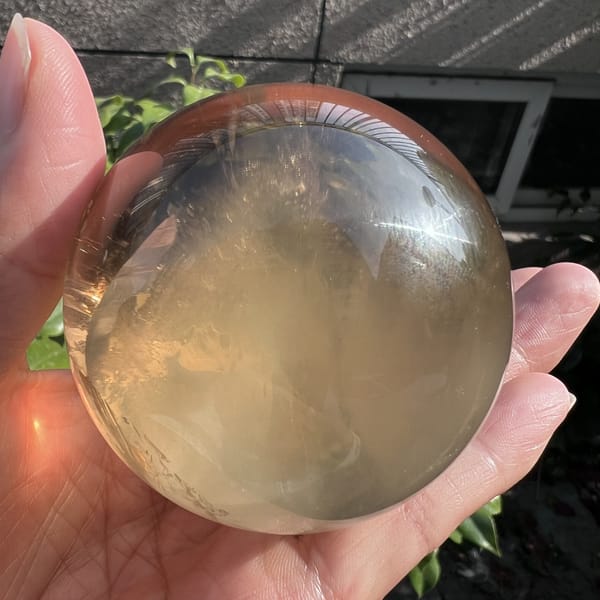 Citrine ball tilted to show warm smoky tones and fine inclusions