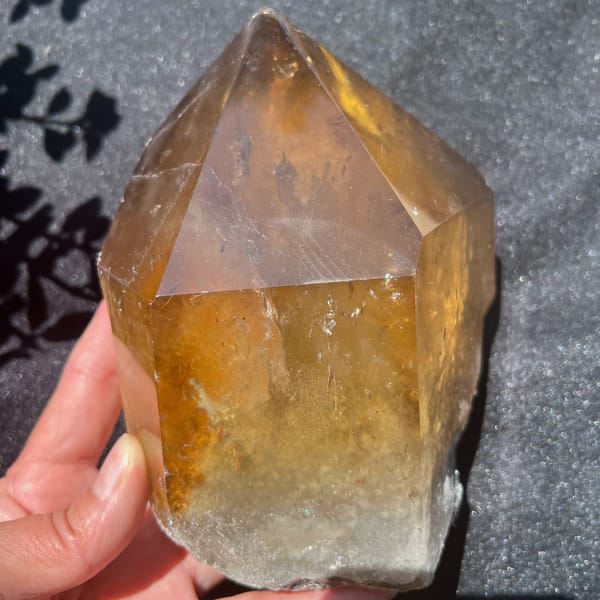 Front face of the golden citrine showing a large triangular polished facet