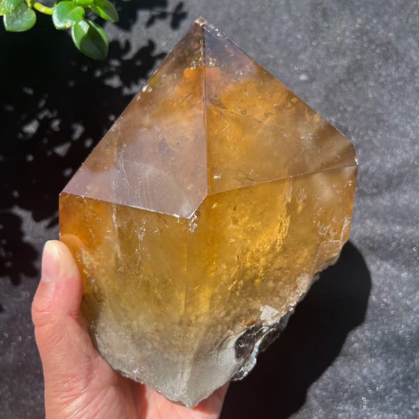 Citrine freeform with a green leaf at the corner and grey-white natural base