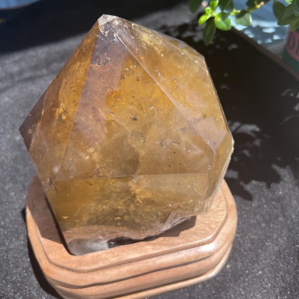 Citrine on its stand showing a dark speckled zone in the lower body