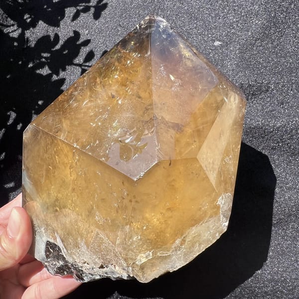 Back of the citrine freeform with a broad V-shaped face and rainbow flecks