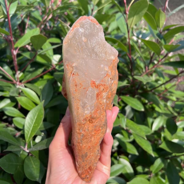 Narrow edge of the citrine covered in rust-orange staining