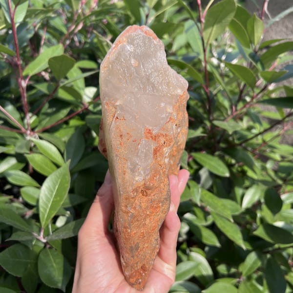 Edge of the citrine with rust-coloured surface and pale crystal tip