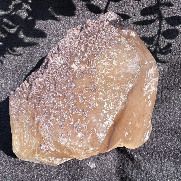 Lepidolite crust spreading over the left side of the citrine crystal