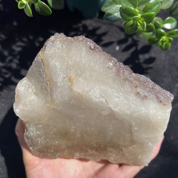 Milky pale underside of the citrine with a thin band of lepidolite