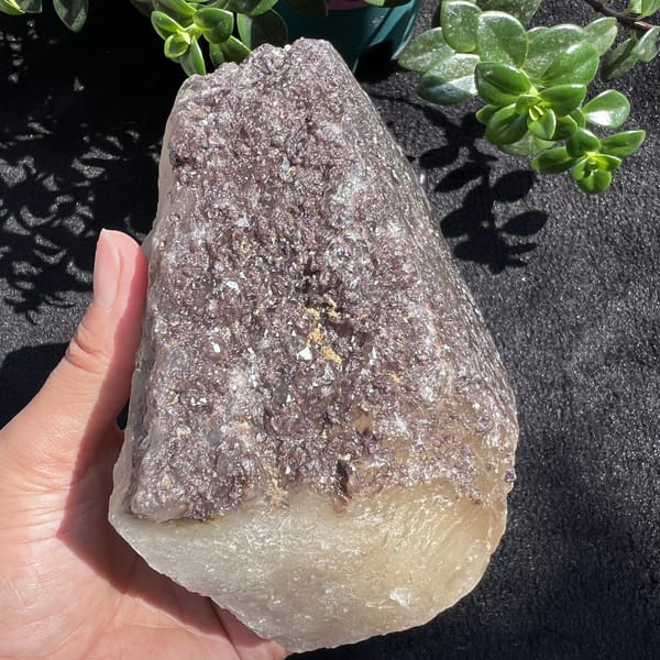 Lepidolite-covered side of the citrine standing upright in hand