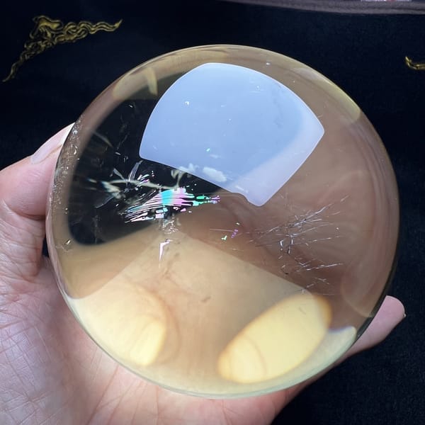 Large citrine sphere with a small rainbow streak and clear body
