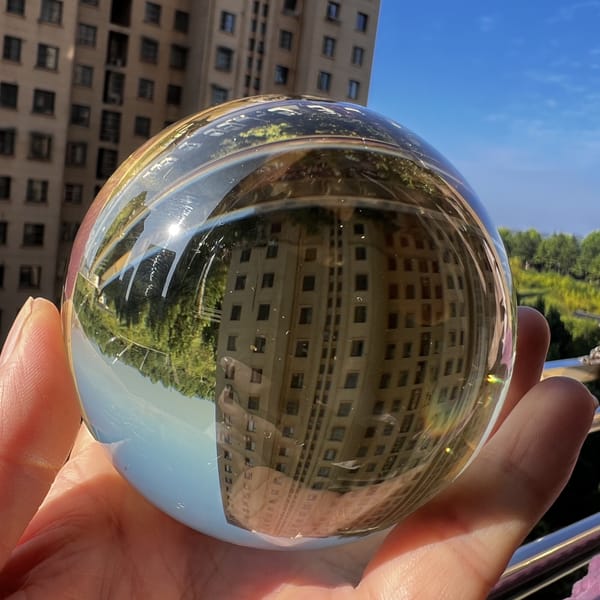 Straw-tinted citrine sphere in sunshine showing exceptional clarity