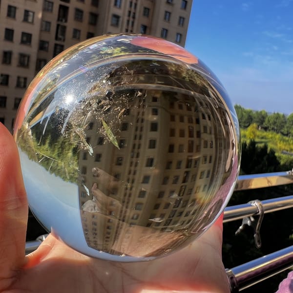 Citrine sphere outdoors with a fine inclusion veil near the top
