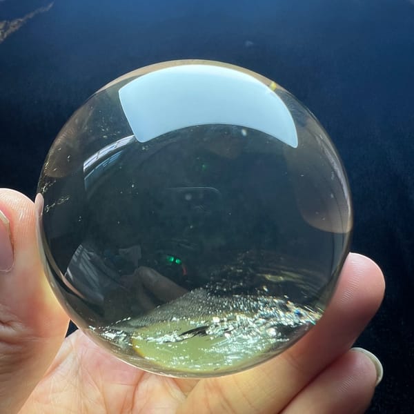 Very clear citrine sphere with a thin band of inclusions near the base
