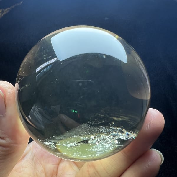 Clean citrine sphere with faint inclusions along the bottom edge