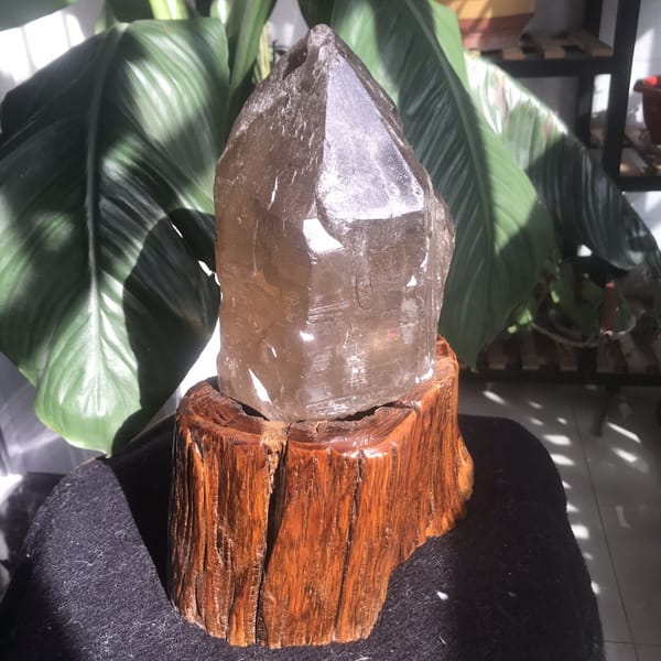 Citrine skeletal crystal on stand, smoky tip and pale lower body