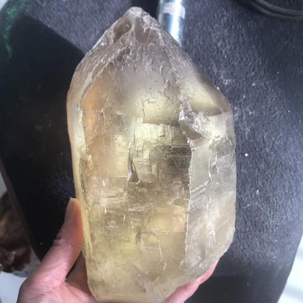 Backlit citrine glowing champagne gold through its frosted surface