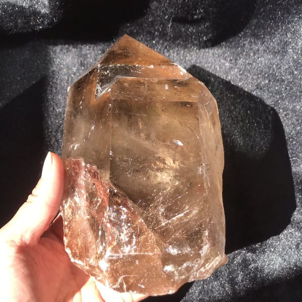 Three-quarter view showing polished faces meeting the rough rutile section