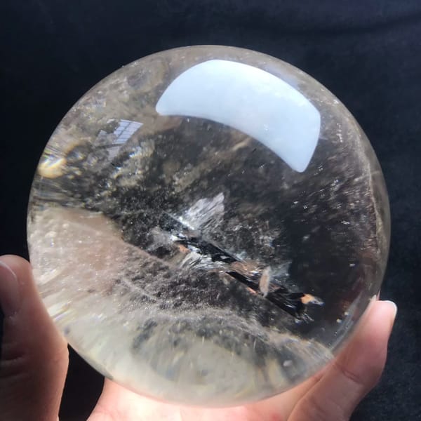 Needle lying horizontally above a misty veil inside the large sphere