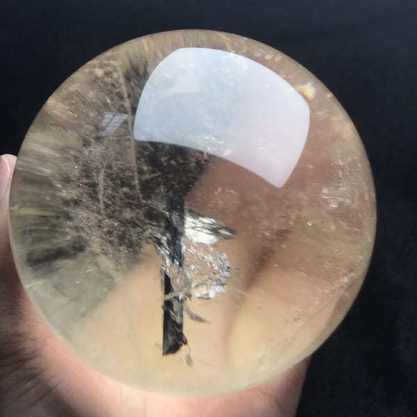Upright tourmaline needle with fanned silver flakes like small branches