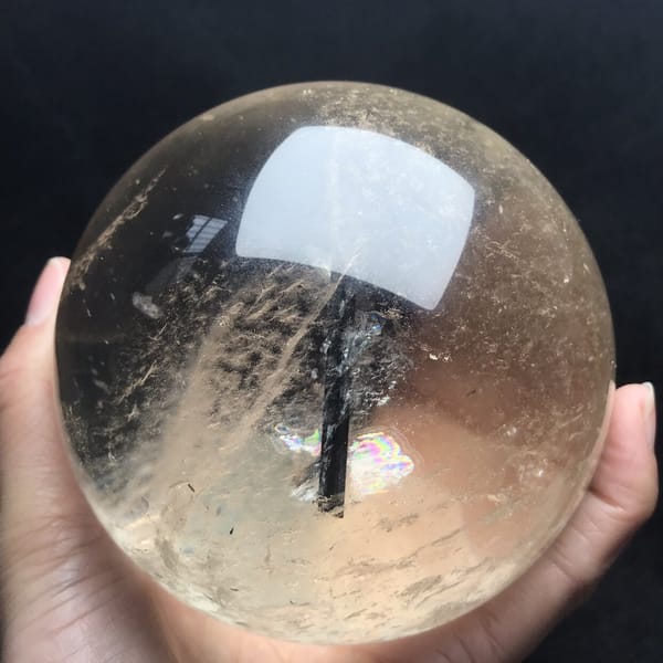 Full view of the sphere showing the needle, veils and soft yellow tone