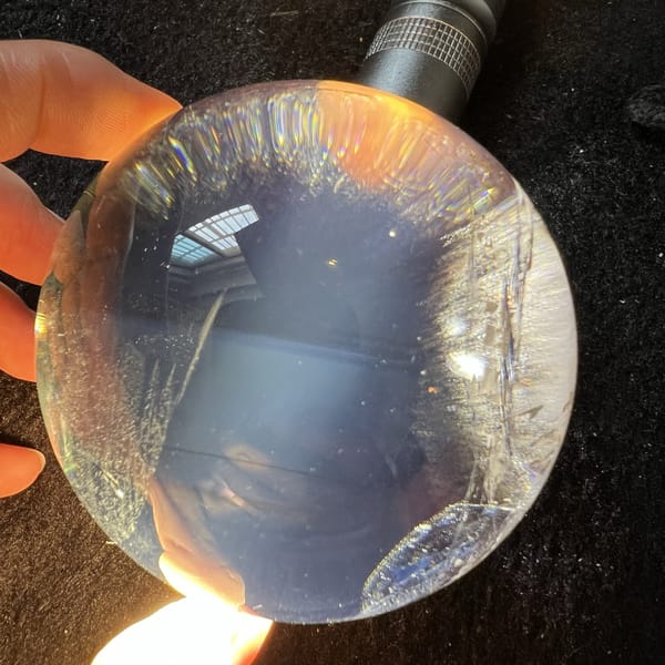 Torchlit sphere with misty blue glow and icy fractures near one side