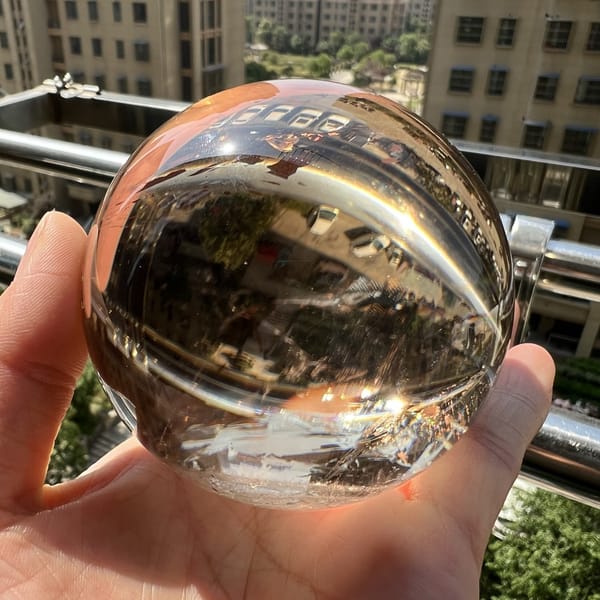 Smoky citrine sphere glowing amber at the edges in direct sunlight