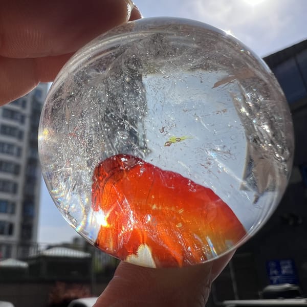 Ember-like red hematite patch seen at an angle against tall buildings