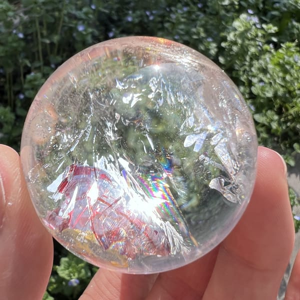 Rainbow sheen across the red patch with clear quartz and veils above