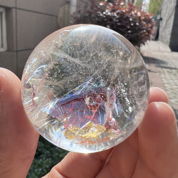 Purple-gold iridescence on the inclusion as the sphere is turned in daylight
