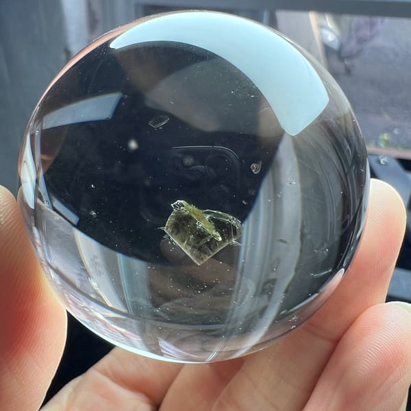Polished ball with the mica heart near the middle and a few tiny specks