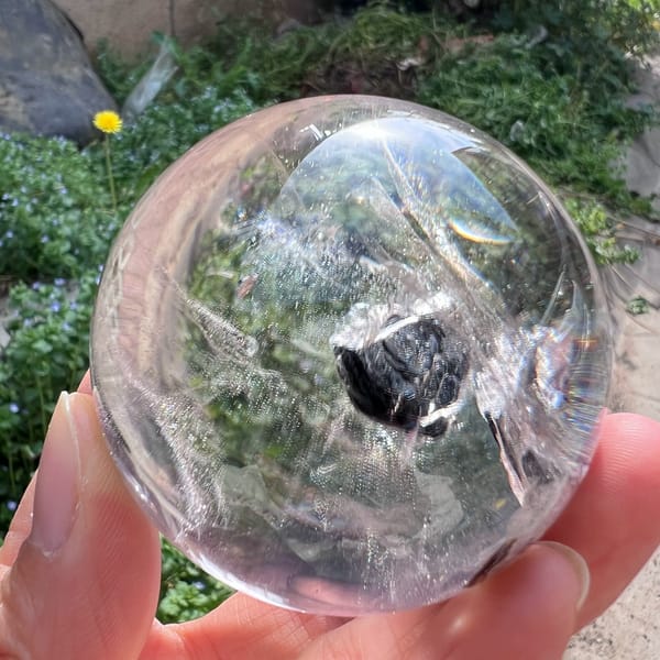 Dark mica flower glinting black in the middle of the clear quartz