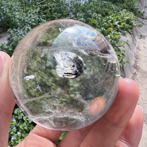 Mica flower centred in the sphere with a faint rainbow at the top
