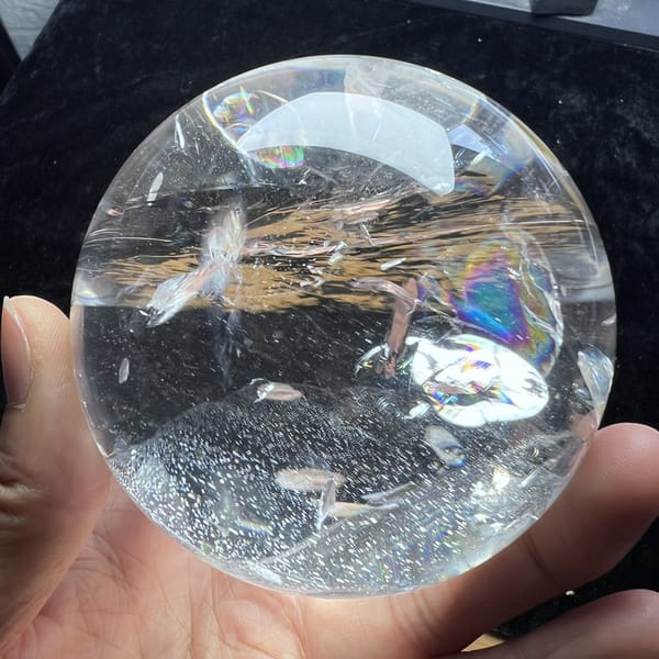 Band of golden fibres and sparkling specks crossing the clear quartz