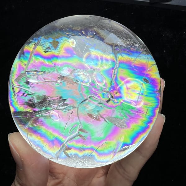 Bright rainbow ring circling the upper half of the crystal ball