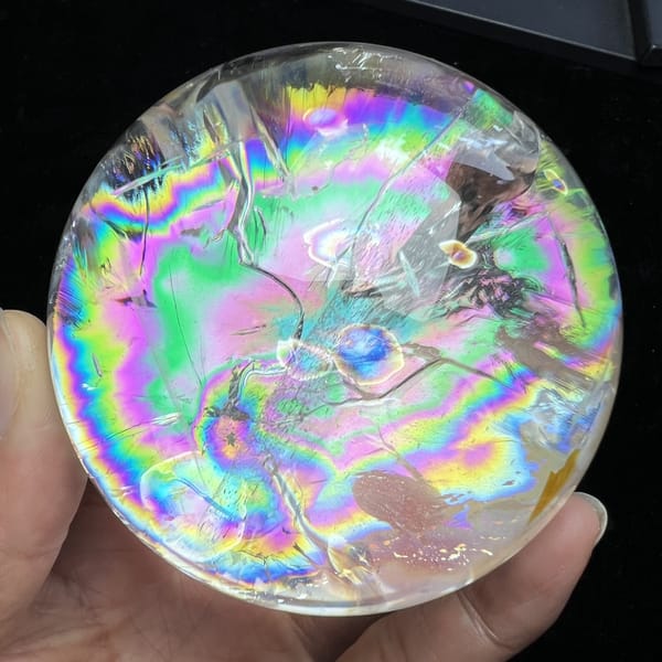 Rainbow bands and fracture lines filling the face of the sphere