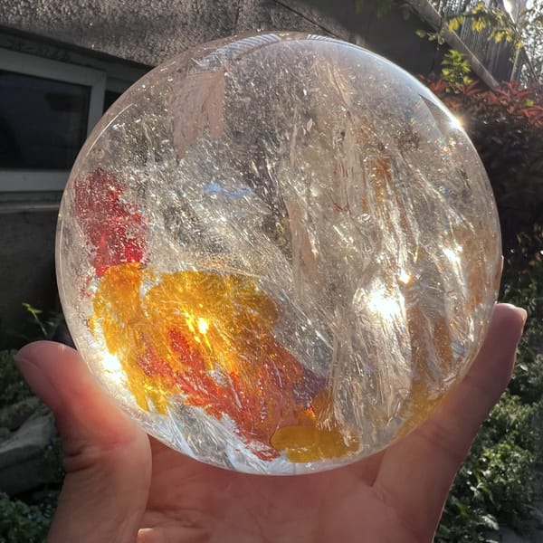 Glowing golden patch beneath red inclusions with veils rising above